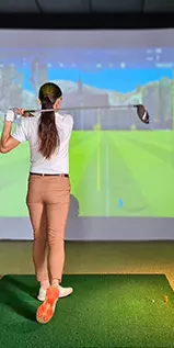 woman using a golf simulator