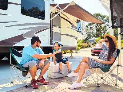 Family sitting outside of RV